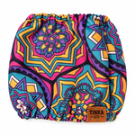 A reusable cloth diaper with a vibrant, multicolored mandala pattern in pink, purple, yellow, and teal, featuring a brown leather patch with the brand name 'TINKA' on the bottom right.