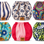 Six dogs snoods arranged in a 2x3 grid on a white background. Each diaper has a different print: navy and cream stripes, navy floral, multicolor mandala, turquoise floral, solid pink, and navy green-and-white floral.
