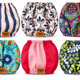 Six dogs snoods arranged in a 2x3 grid on a white background. Each diaper has a different print: navy and cream stripes, navy floral, multicolor mandala, turquoise floral, solid pink, and navy green-and-white floral.