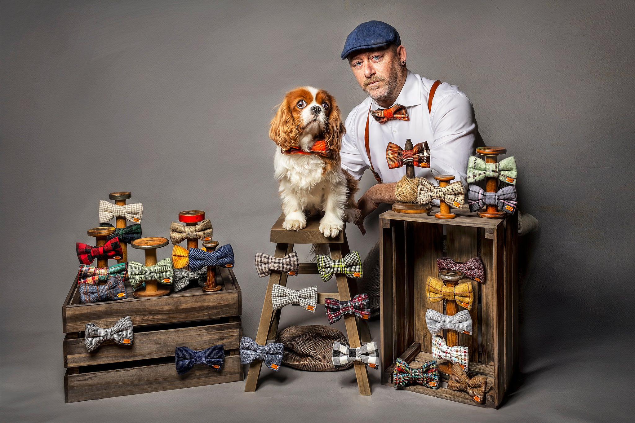 Man and dog with bow tie display on a gray background